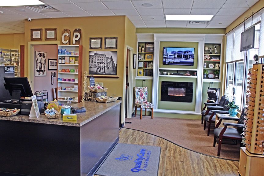 Clarence Pharmacy interior with CP logo on wall